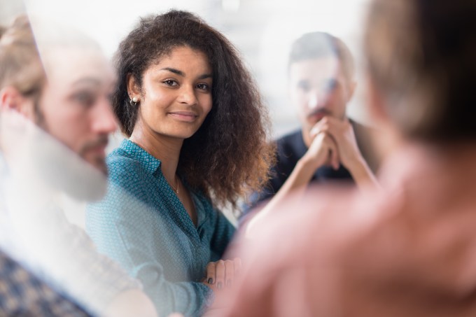 Meeting at the startup office . A working group meets to study a new project.